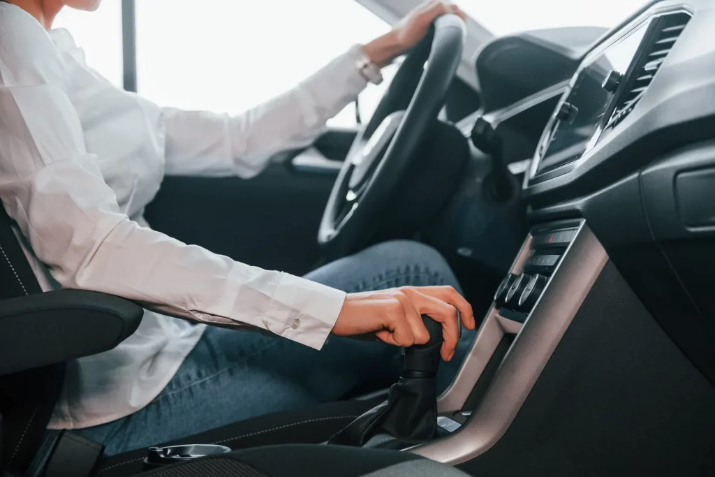 Learner adjusting the gear selector during a lesson with Driving Instructors in a modern car.