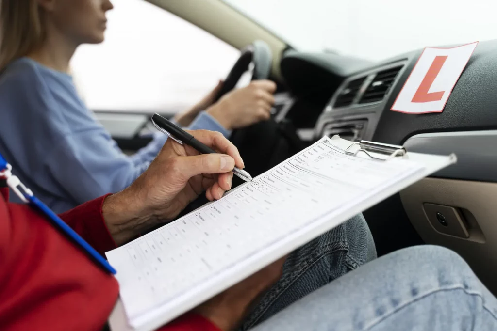 Driving instructor marking a learner's test sheet during a lesson, showing the process behind how much is an intensive driving course